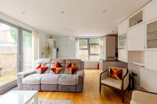 a living room with a couch and a table at Modern City Centre House with Free Parking in Canterbury