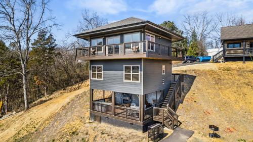 a house on a hill with a dog on a balcony at Smokies Treehouse in Sevierville