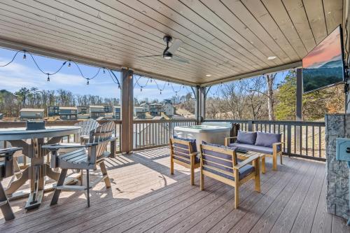 a wooden deck with a table and chairs on it at Smokies Treehouse in Sevierville