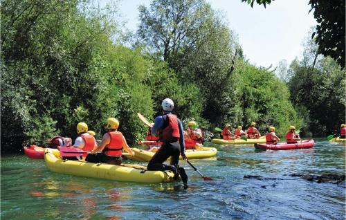 a group of people are rafting on a river at 3 Bedroom Cozy Home In Hrvace in Hrvace