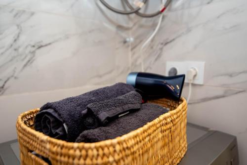 a basket with a hair dryer on top of a towel at Private residence - Just like home in Agadir
