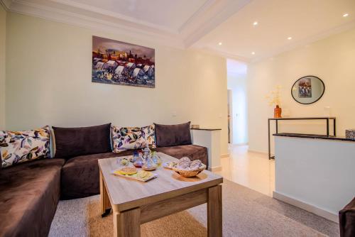 a living room with a couch and a table at Private residence - Just like home in Agadir