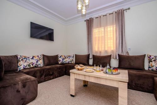 a living room with a couch and a table at Private residence - Just like home in Agadir