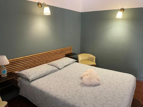 a bedroom with a bed with a stuffed animal on it at Casa Mia Bogliasco Mare & Centro in Bogliasco