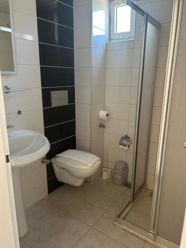 a bathroom with a toilet and a sink at Family Apart in Marmaris