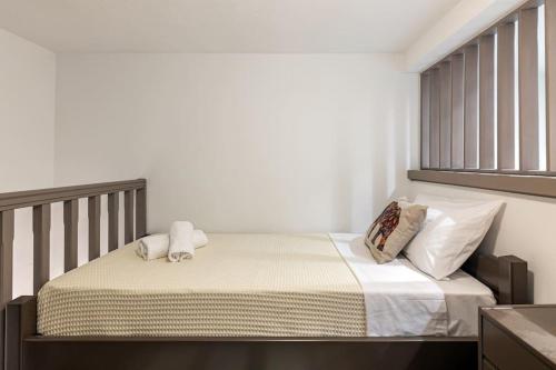a bed with two pillows on it in a bedroom at Rizes House in Zarós