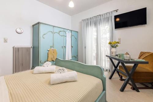 a bedroom with a bed and a table with a desk at Rizes House in Zarós