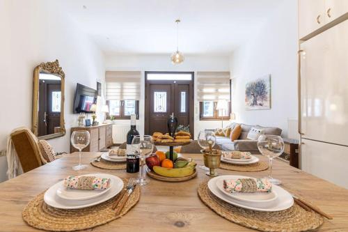 a dining room table with food and wine glasses at Rizes House in Zarós