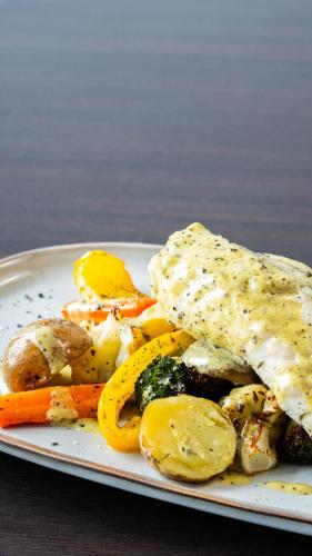 a plate of food with eggs and vegetables on a table at Hótel Flókalundur in Brjánslækur