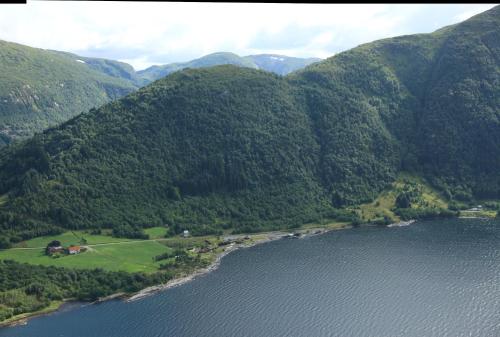 an aerial view of a mountain range with a lake at Brekkestranda Fjordhotel in Brekke