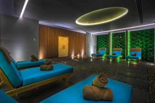 a waiting room with blue furniture and green walls at Arts Hotel Bodrum Yalikavak in Yalıkavak