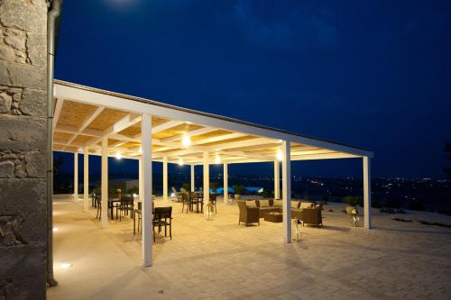 a pavilion with tables and chairs at night at Dépendance Dimora di Spartivento in Ragusa