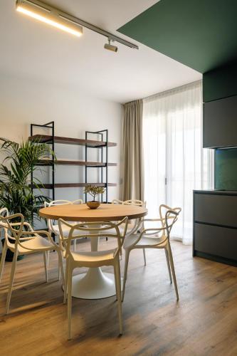 a dining room with a table and chairs at Camoma Aparthotel - Suites Apartments in Jesolo