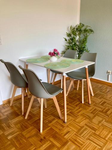 a dining room table with four chairs and a plant at Waldglück in Wolfshagen