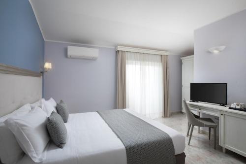 Postel nebo postele na pokoji v ubytování Hotel Rosa dei Venti
