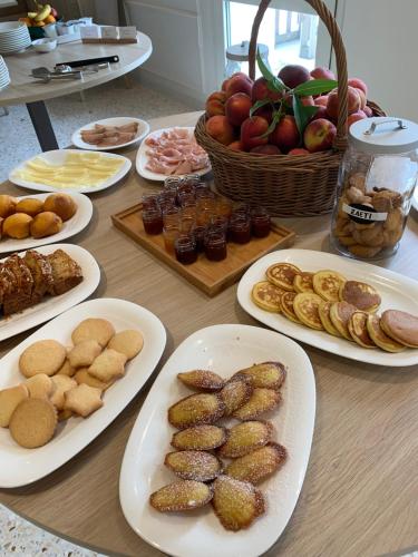 a table topped with plates of food and appetizers at Agriturismo Zapparè Farm Hotel in Trevignano
