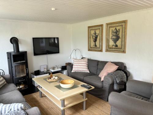 a living room with a couch and a coffee table at Feriehus Vrensted-Løkken in Løkken