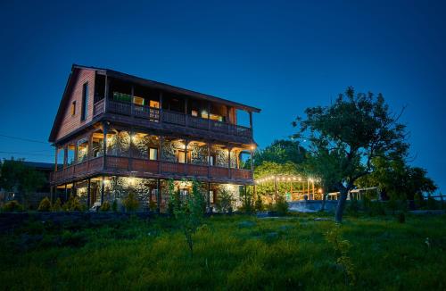 a large building with lights on it at night at Edis Dacha in Tsalka