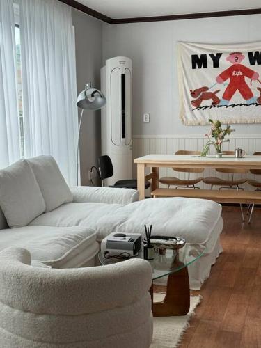 a living room with a white couch and a table at Perfect location Haenggung in Suwon