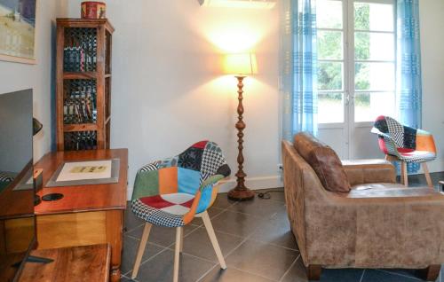 a living room with two chairs and a lamp at Château De Grenier Gite in Saint-Léger