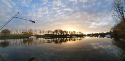a view of a river with a crane at les forges du lou in Jugon Les Lacs