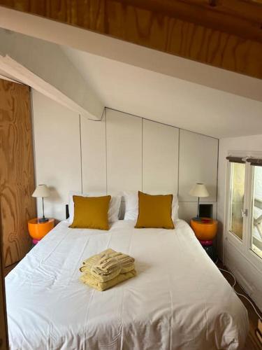 - un lit blanc avec un tas de serviettes dans l'établissement Lovely cosy flat, à Bordeaux