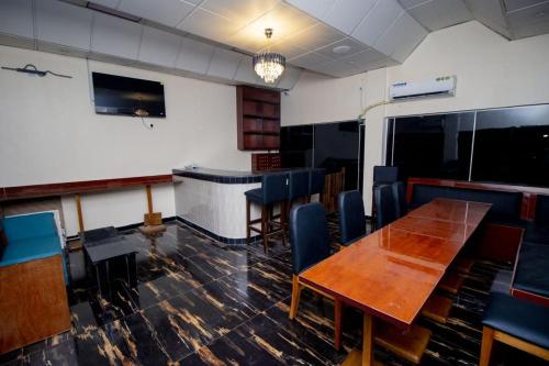 a dining room with a table and chairs at LINKS Bed and Breakfast in Abeokuta