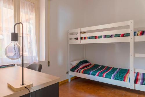 a bedroom with two bunk beds and a desk at Argentario Retreat Sea View Terrace, WiFi & Private Parking Included in Porto Santo Stefano