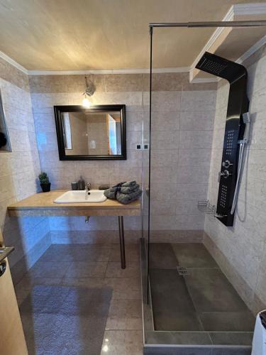 a bathroom with a sink and a shower at Sun Castle Houses in Drymon