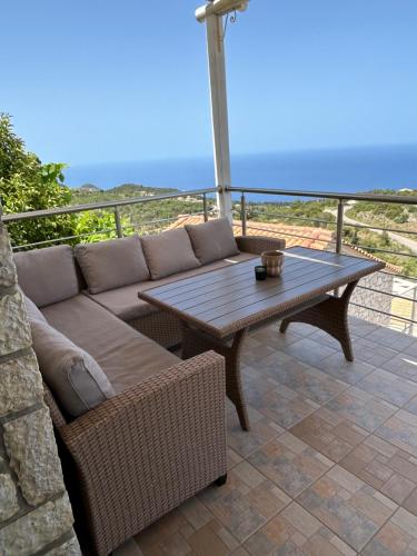 a patio with a couch and a table on a balcony at Sun Castle Houses in Drymon
