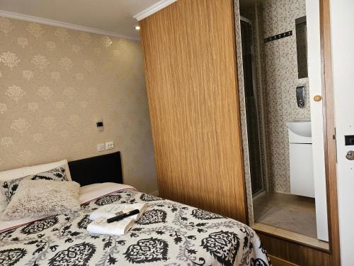 a small bedroom with a bed and a bathroom at Charme da Graça - Guest House in Lisbon