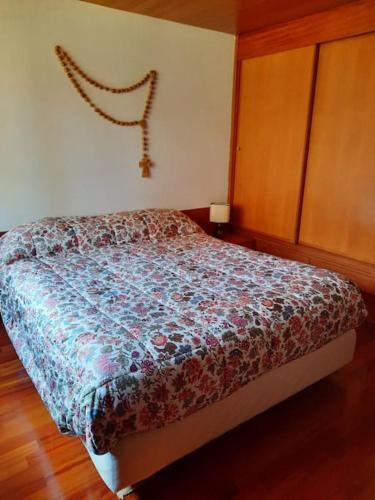 a bedroom with a bed with a colorful comforter at Casa StePa in Pescasseroli