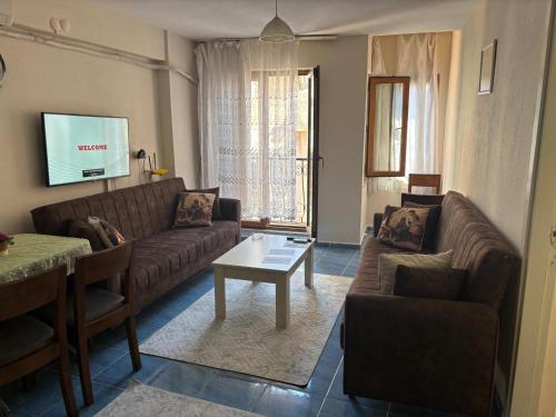 a living room with a couch and a table at Efe Can Apart Otel in Canakkale