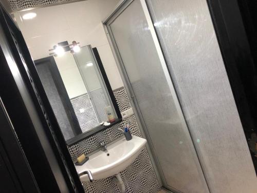 a bathroom with a sink and a shower at Luxury Stay in Tetouan