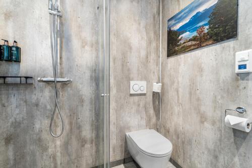 a bathroom with a shower and a toilet in it at Lyngseidet Gjestegård AS in Lyngseidet