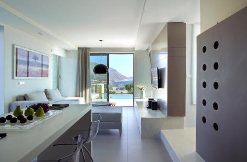 a kitchen and living room with a couch and a table at Youphoria Sea View Villas in Kissamos