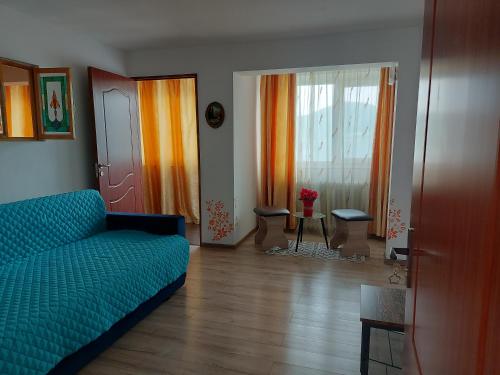 a living room with a couch and a window at Casa Yuppy Du in Eşelniţa