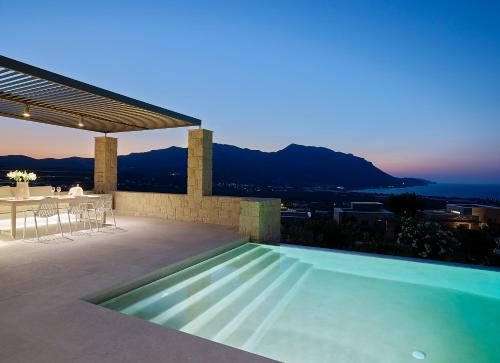 a villa with a swimming pool at dusk at Youphoria Sea View Villas in Kissamos