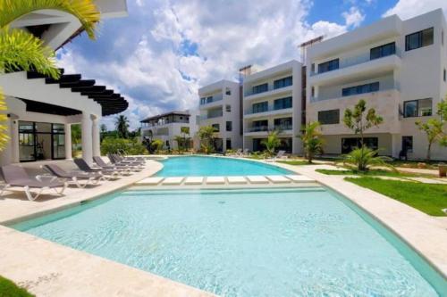 a swimming pool in front of a building at Amare Beach Front Condo in Las Terrenas