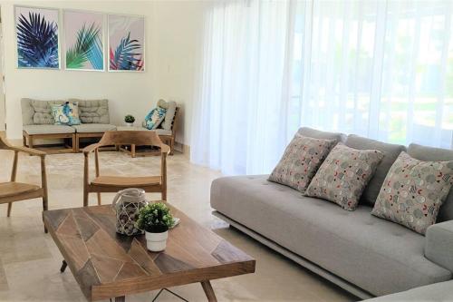 a living room with a couch and a table at Amare Beach Front Condo in Las Terrenas