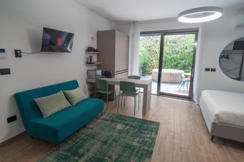 a living room with a blue couch and a table at VELVET HOME Pescara - Luxury Apartment in Pescara