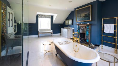 a bathroom with a tub and a glass shower at Lissadell on The Beach in Lissadell