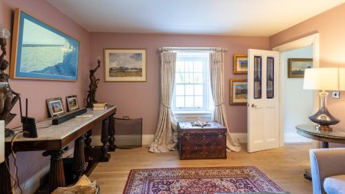 a living room with a desk and a window at Lissadell on The Beach in Lissadell