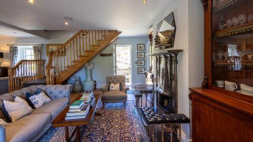 a living room with a couch and a staircase at Lissadell on The Beach in Lissadell