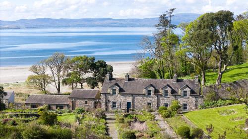 an old house on a hill next to a body of water at Lissadell on The Beach in Lissadell