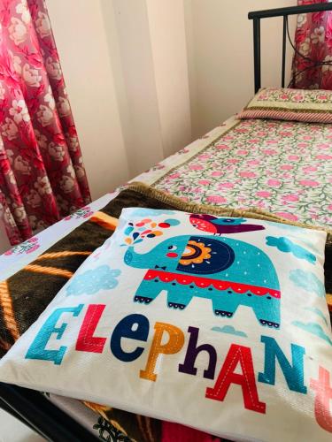 a bed with an elephant blanket on it at Windchime9 in Guwahati