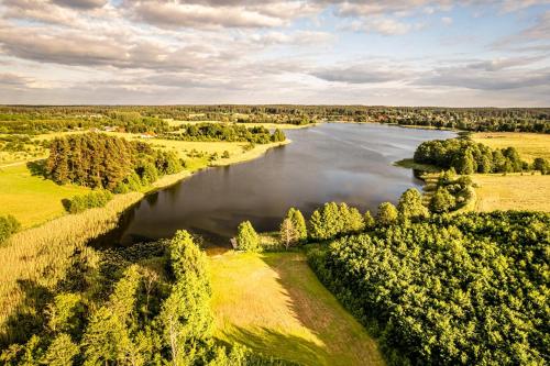 an aerial view of a river in a field at Między Olchami 2 in Barczewo