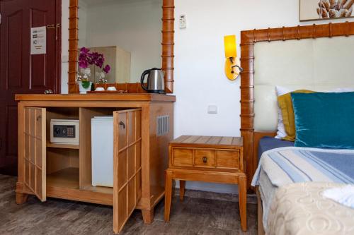 a bedroom with a bed and a night stand next to a bed at London Hotel in Oludeniz