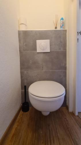 a bathroom with a toilet with a sign on the wall at Kamus in Baden-Baden