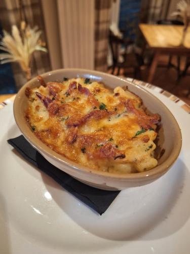 a bowl of food on a plate on a table at George & Dragon Country Pub & Hotel Wolverton Townsend in Tadley